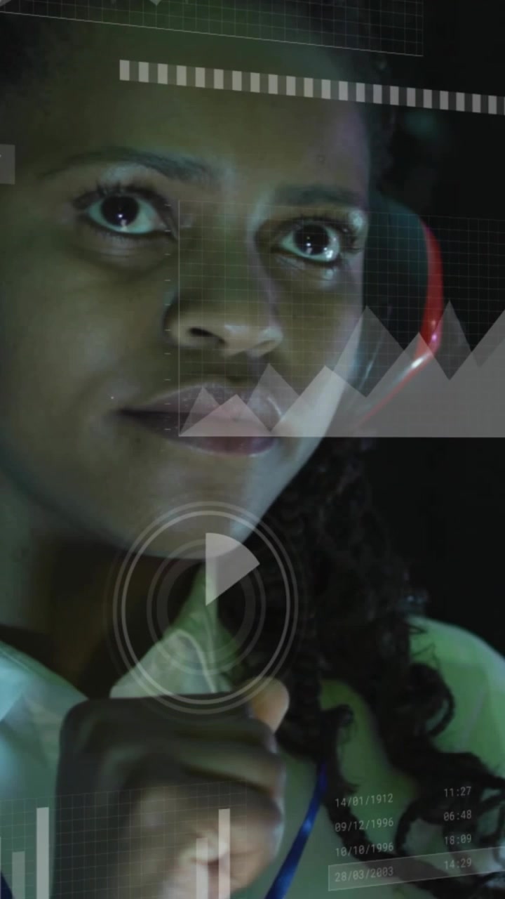 Tech analyst woman receiving data feed, raising fist under chin examining HUD charts and readouts