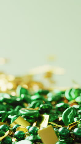 vertical video of of st patrick's green necklace and sequins with copy space on green background