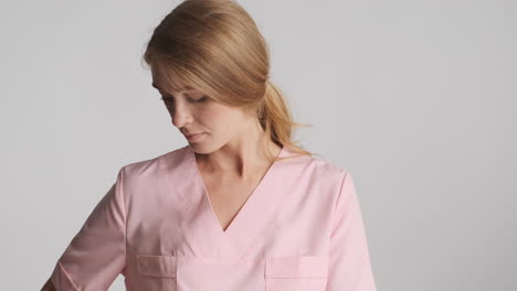 caucasian female doctor wearing medical gloves using hand sanitizer.