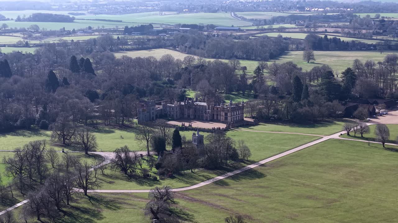 Knebworth House, grand view with lush fields and architectural beauty