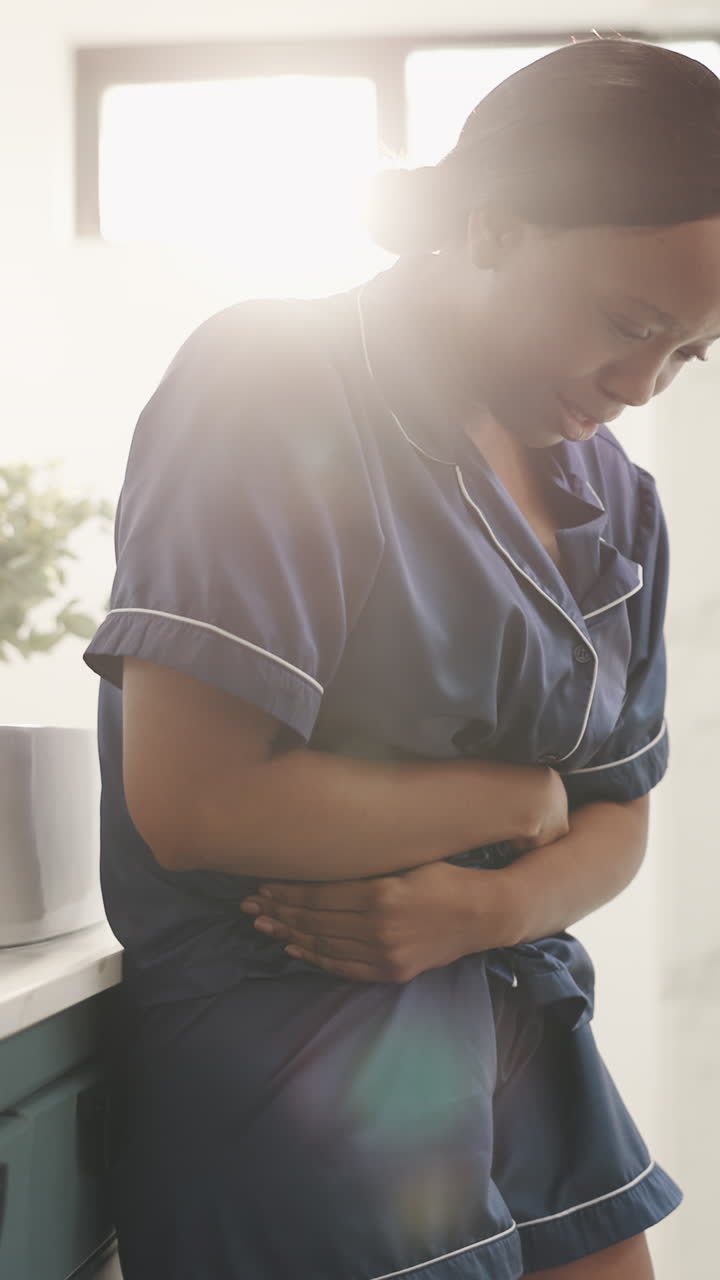 Young Woman Suffering from Stomach Pain at Home