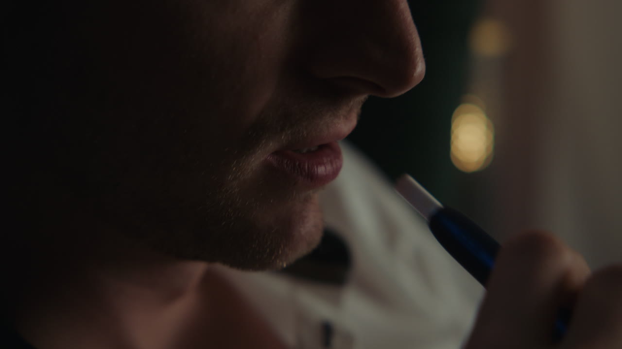 Man Smoking a Pipe at Night