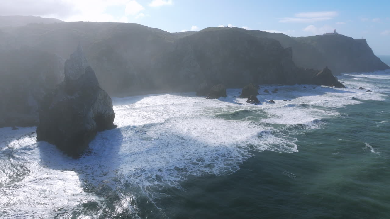 Wide aerial shot of Praia da Ursa by Cabo da Roca, Portugal, showcasing the coastline in the early morning