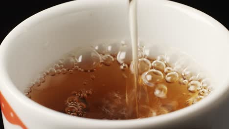 pouring tea into a cup