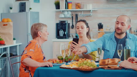 Woman-using-phone-during-dinner