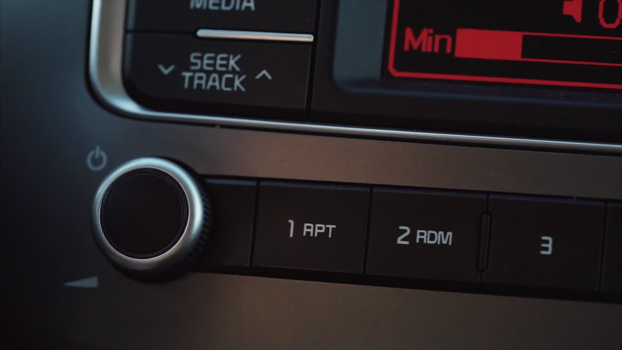 Person Adjusting Car Radio Controls