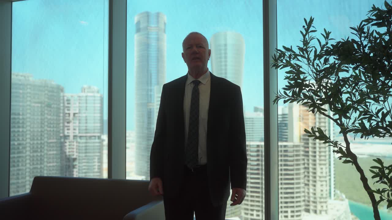 Irate businessman in an office yelling as he fires someone or is fired - slow motion skyscraper city view