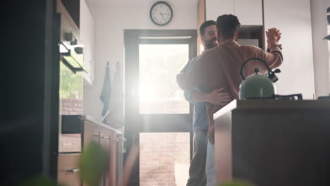 happy couple dancing in the kitchen