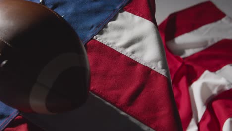 close up studio shot of american football on stars and stripes flag 5