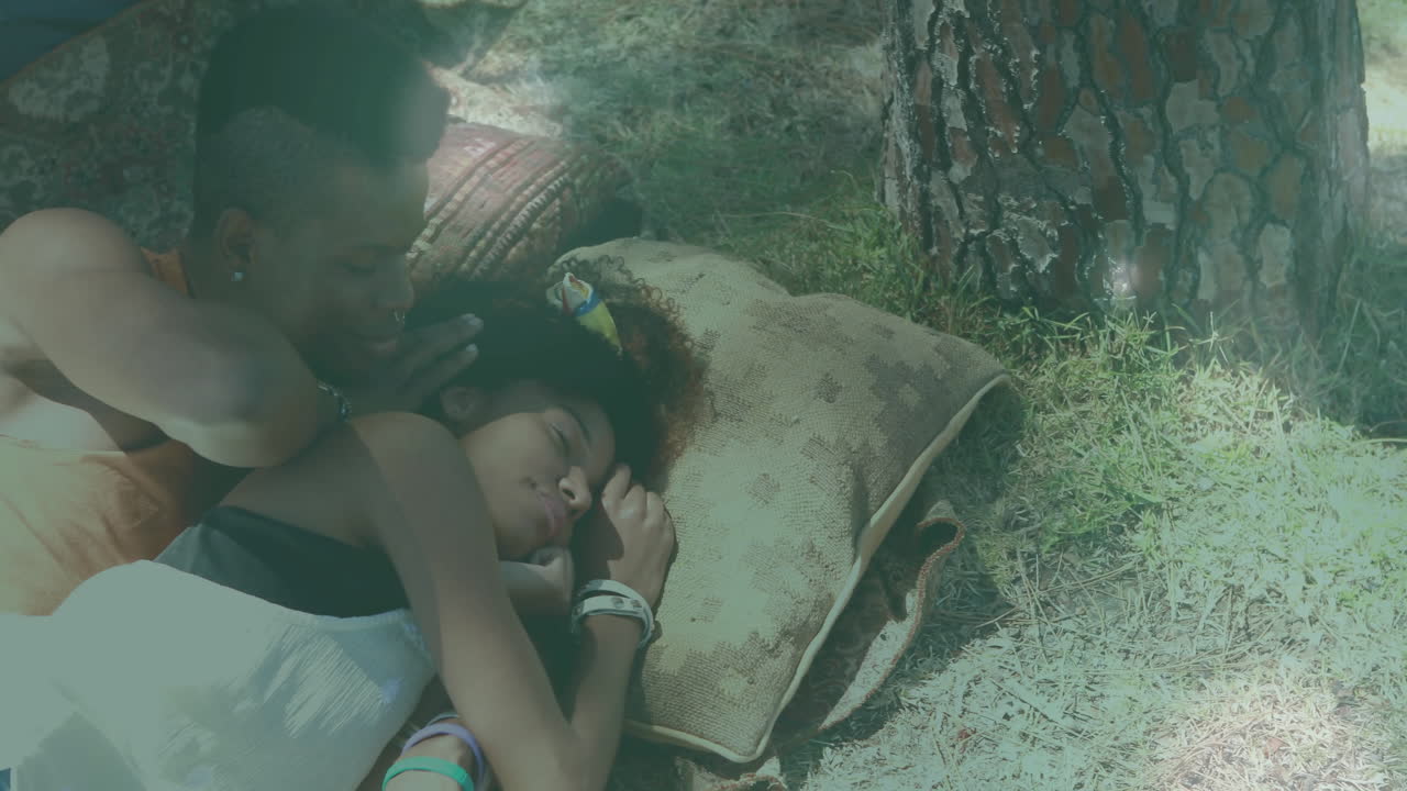 Couple relaxing under tree with pillows, enjoying peaceful outdoor animation