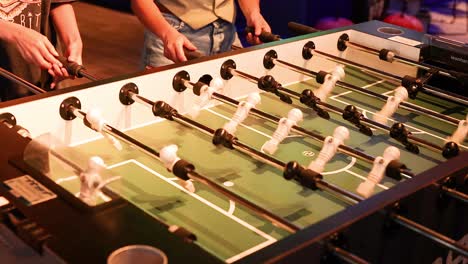 players engaged in a lively foosball match