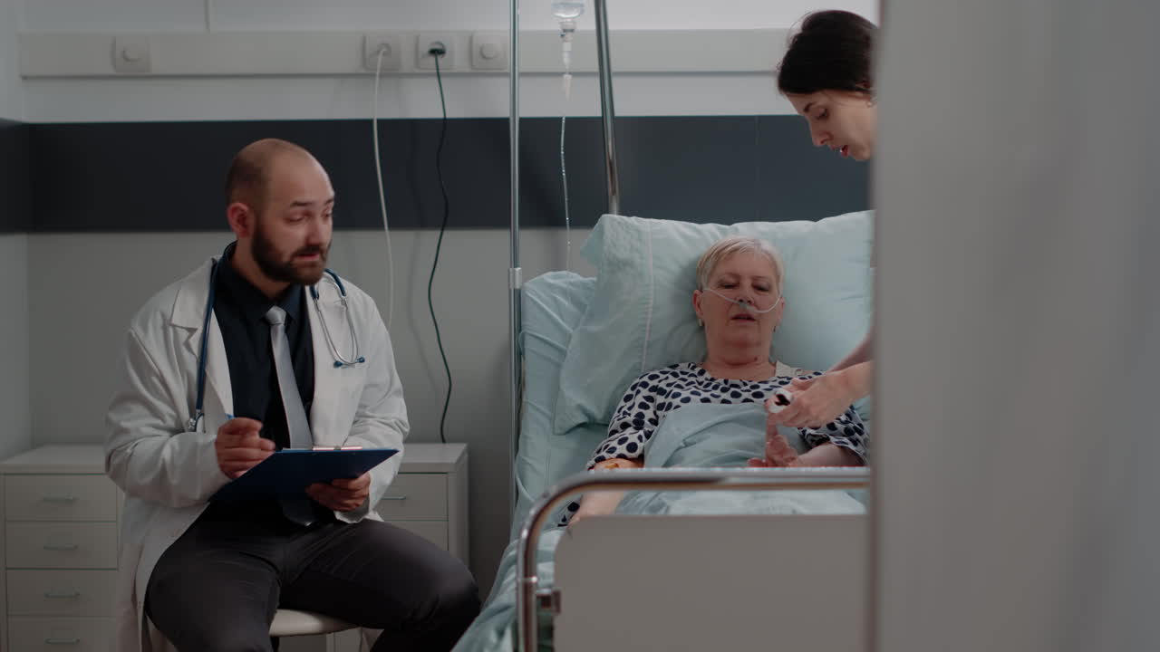 Doctor and nurse doing healthcare consultation with elder woman