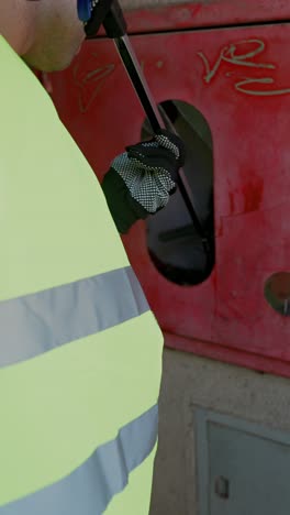 worker cleaning fire safety box