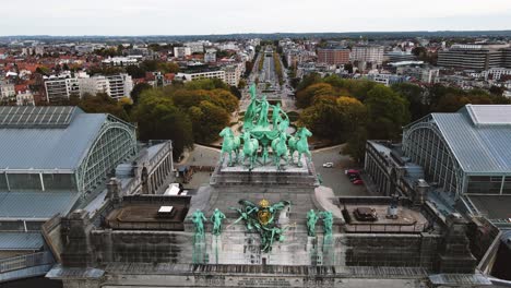 rising aerial view of the triumphal arch and the city of brussels on the horizon