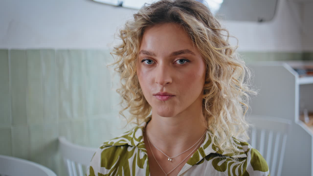 Serene woman sitting cafeteria touching hair closeup. Portrait of relaxed lady