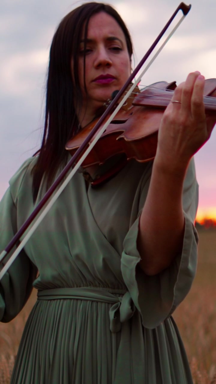 Woman Playing Violin in a Wheat Field at Sunset