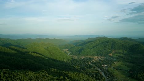 4K-Cinematic-nature-aerial-footage-of-a-drone-flying-over-the-beautiful-mountains-of-Chiang-Mai,-Thailand-during-sunset