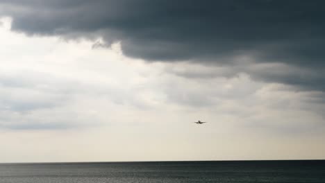plane is flying low over the sea