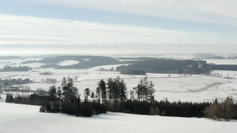 aerial shot of beautiful winter scene of agricultural farm land and road snow covered