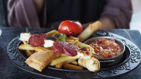 turkish meze platter with fries and grilled sausages