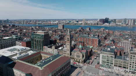 Aerial-view-of-Old-South-Church-surrounded-by-red-brick-apartment-houses.-Wide-riverbed-of-Charles-river-in-background.-Boston,-USA