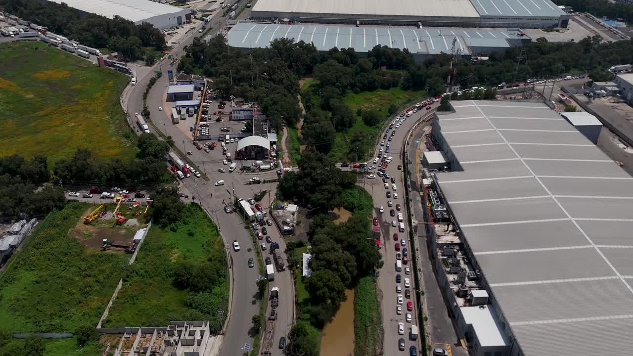 Drone shot of the road intersection with vehicles waiting for the traffic light change at the municipal border between Cuautitlán Izcalli and Tepotzotlán in the metropolitan area of Mexico City