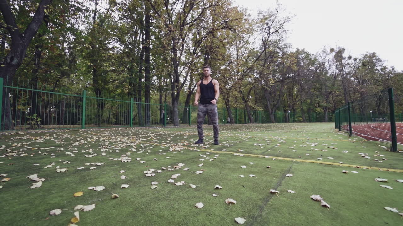Sportsman doing exercise. Fit athlete doing exercises at stadium
