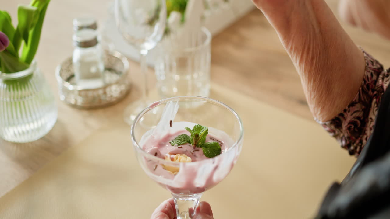Elderly Person Eating Dessert at Restaurant
