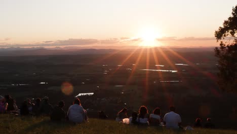 people watching sunset over a scenic landscape