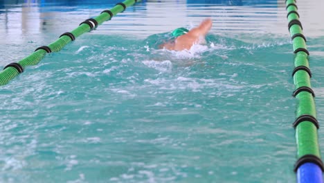 fit swimmer doing the front stroke in the swimming pool