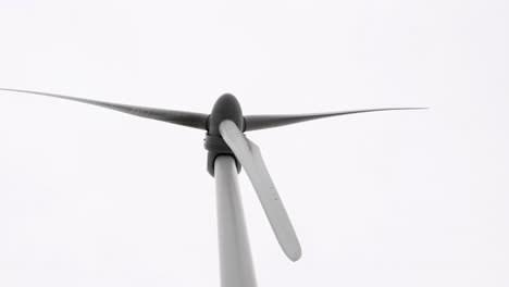 wind turbine blades rotating against the sky