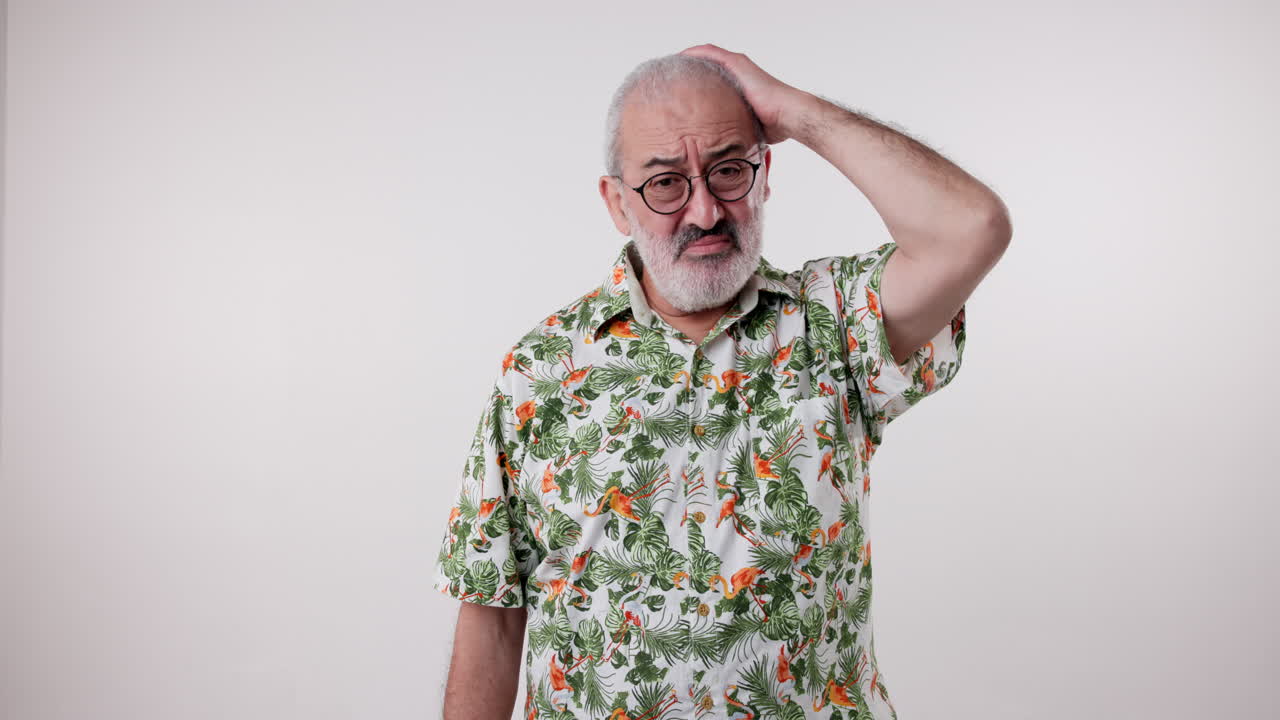 Portrait of a man in a Hawaiian shirt looking confused
