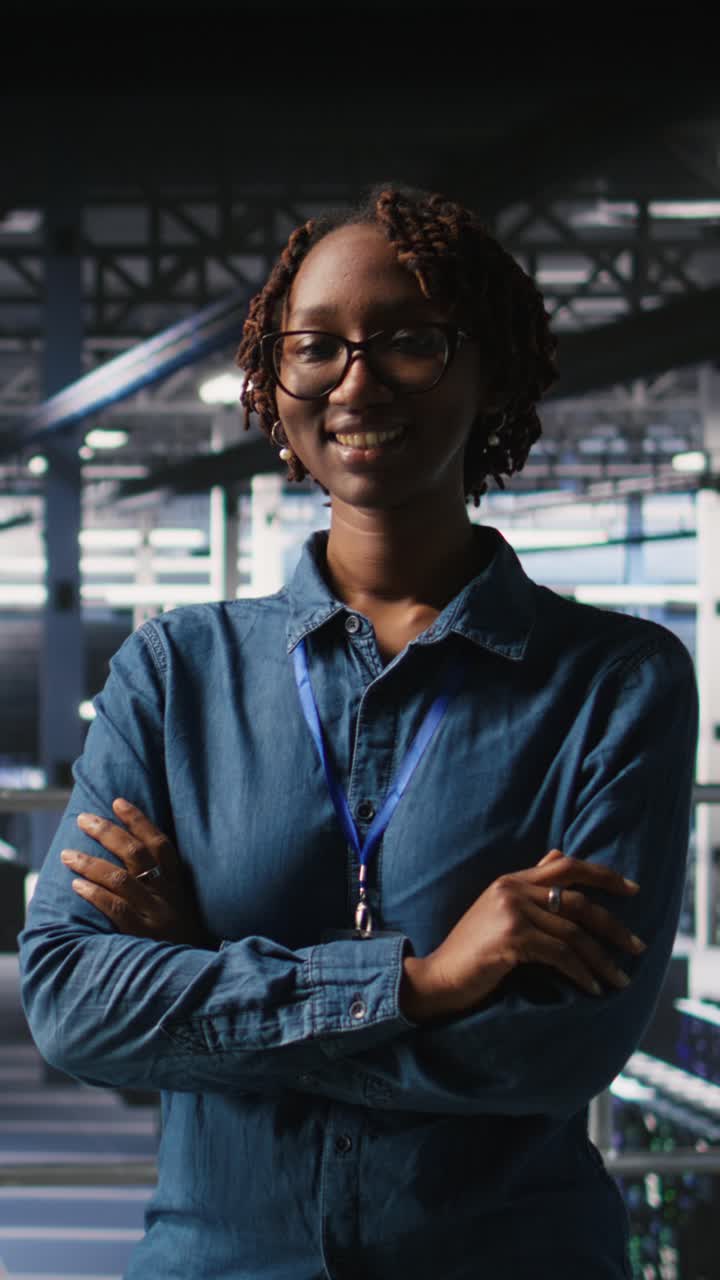 Vertical video Portrait of smiling data center admin next to coworkers