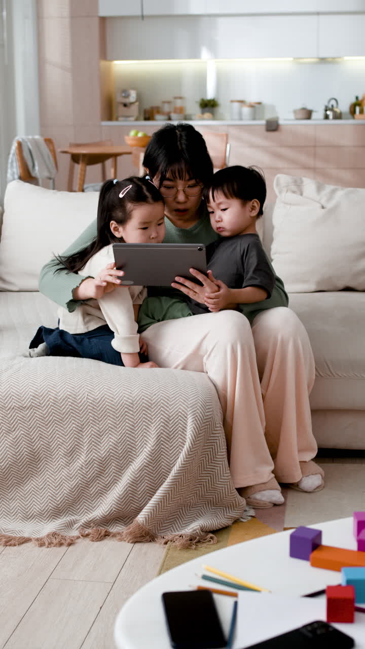 Mother and children watching tablet