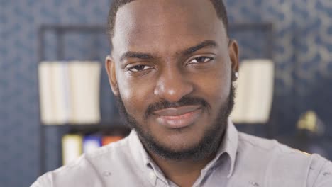 close-up facial expression of black man. he is an office worker.