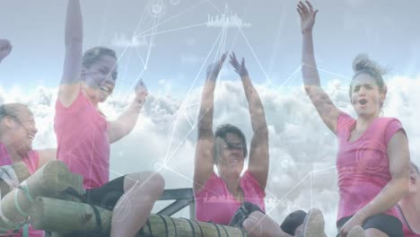 Animation-of-data-processing-and-clouds-over-diverse-women-at-obstacle-course-raising-hands