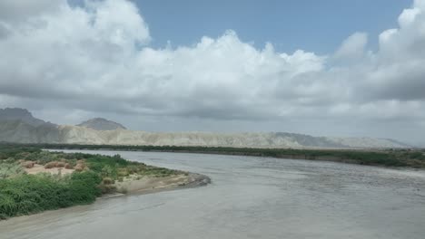 serene hingol river against balochistan hills - aerial