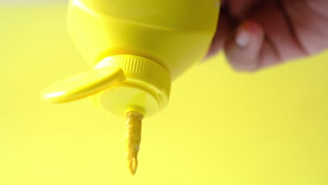 mustard mayonnaise in yellow container on yellow background ,