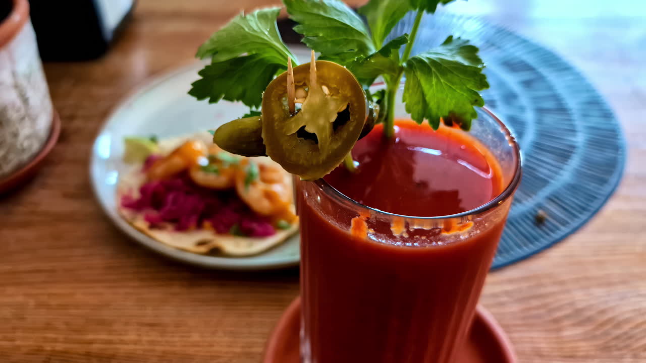 Delicious beetroot juice with leaf and jalapeno on top, close up