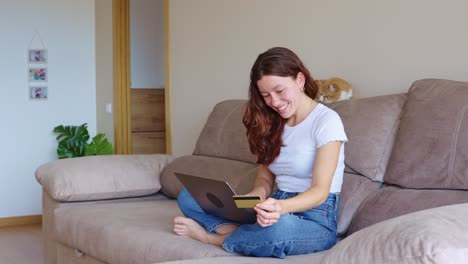 woman shopping online with laptop and credit card at home