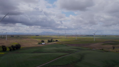 4k-Slow-motion-aerial-footage-of-windmills-over-agricultural-land-in-california