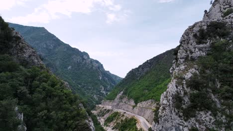 Aerial-shot-of-empty-mountain-road-revealing-ravine