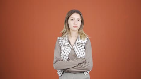 young woman looking at camera with dull expression.