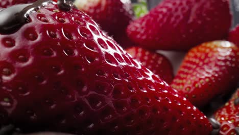 Macro-video-of-juicy-strawberry-covered-with-liquid-chocolate