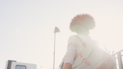 beautiful mixed race woman walking through urban city streets