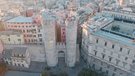 Drone-pullback-reveal-from-historic-Porta-Soprana-,-Genoa,-Italy