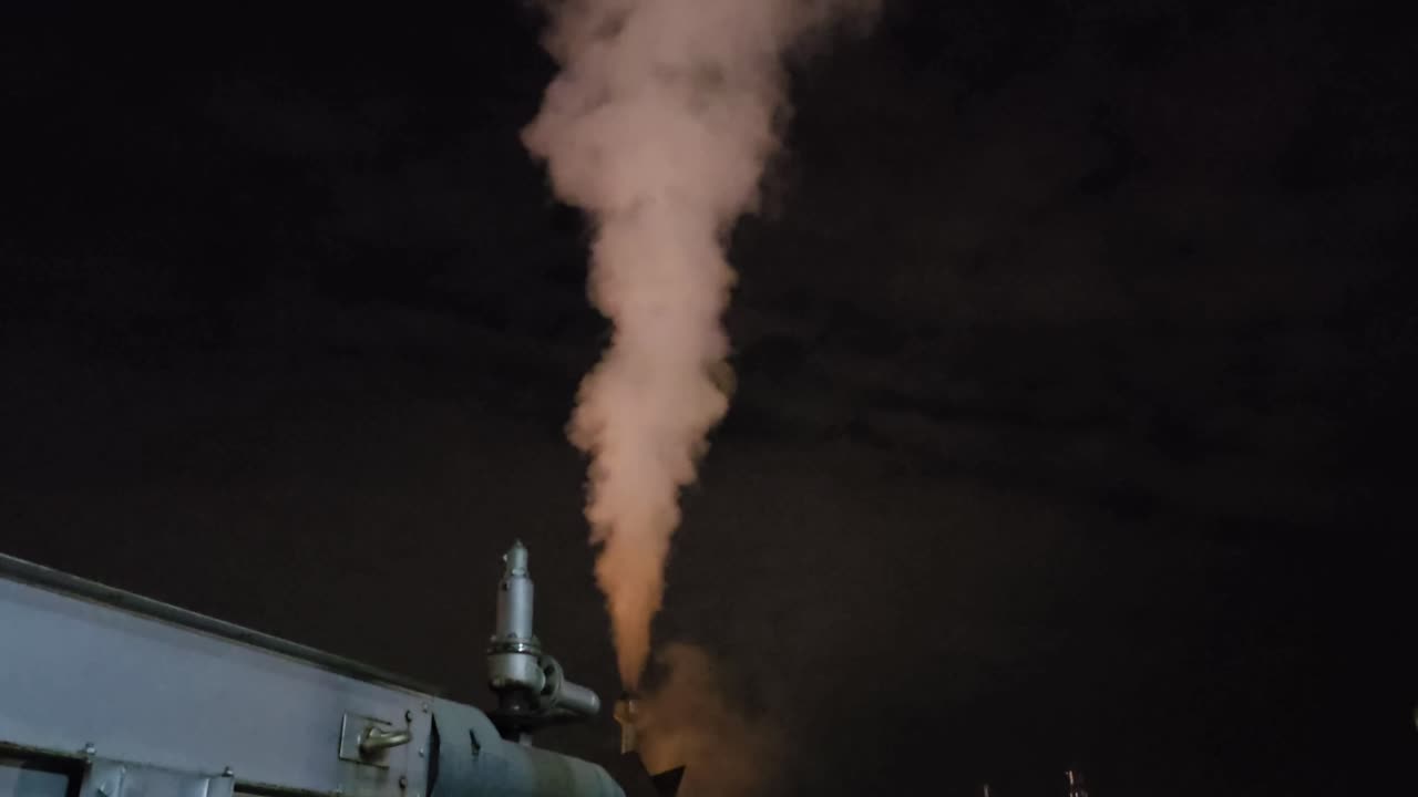 Steam Rising from Industrial Pipe at Night