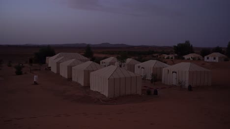 the view of the desert camp from the dunes in morocco, merzouga, africa