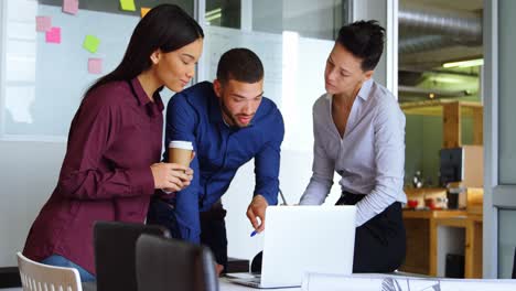 Executives-discussing-over-laptop-4k