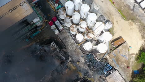 aerial, top down, drone shot of two firetrucks at a burning fire, in santo domingo, dominican republic